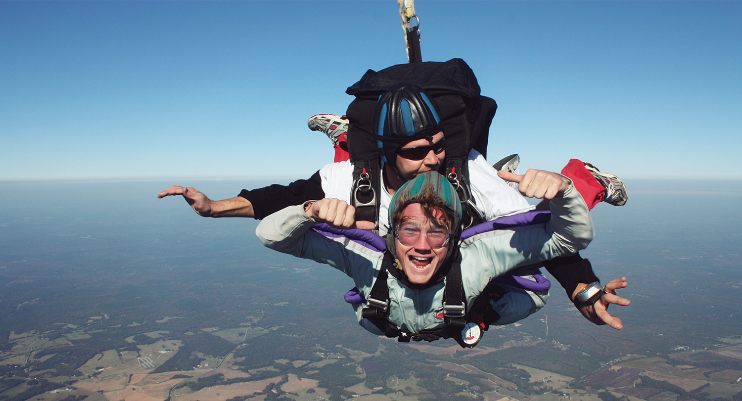 Student flying in the air while skydiving.