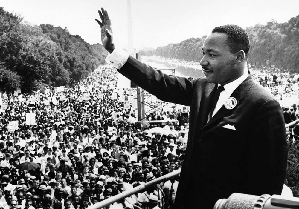 Martin Luther King Jr. waving to a crowd