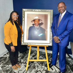 Dr. Shaneen Dials Corujo and Gregory Glover with framed photo of Adrenee Glover Freeman