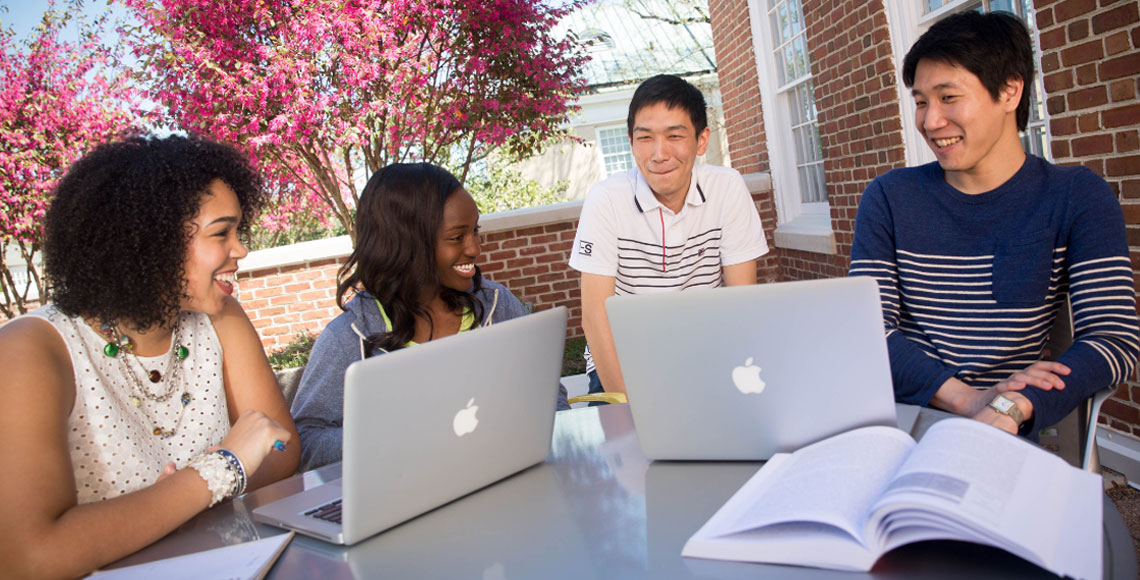 students studying at the russell house patio