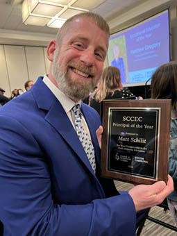 Matt Schilit holding his award