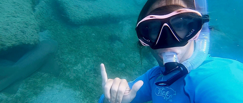 A student takes a selfie whie scuba diving in the Galapagos