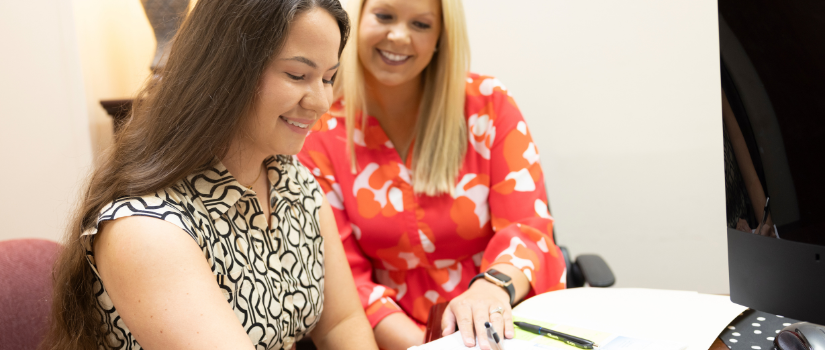 Student and faculty member at desk