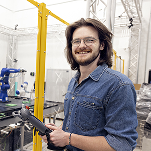 Austin Harper stands in an engineering lab.