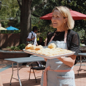 Carrie Morey passes out biscuits outside of Russell House on USC's campus