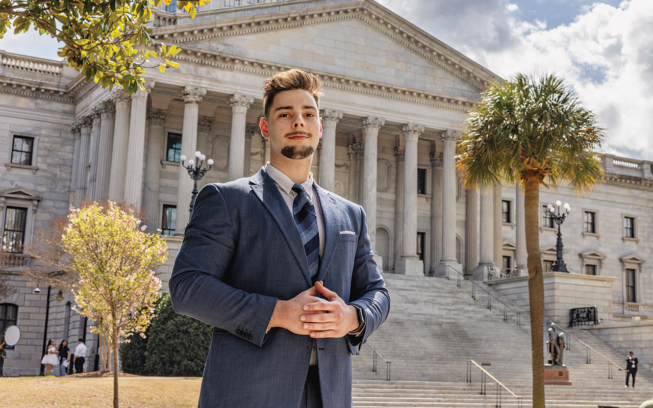 David Kozak stands in front of the South Carolina Statehouse.