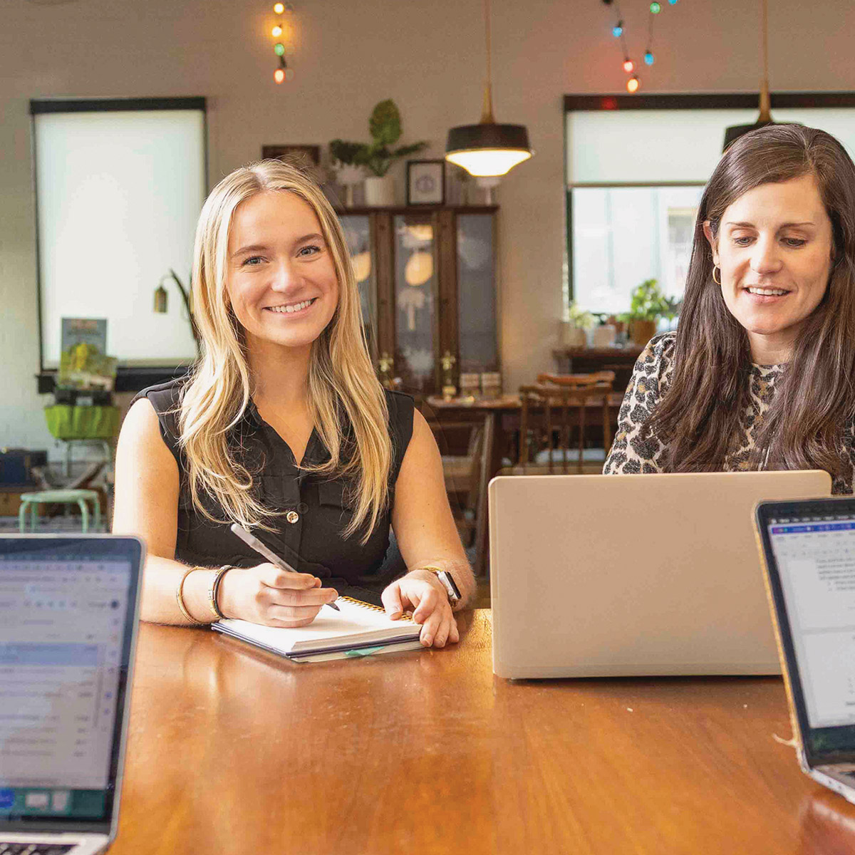 Hannah Uptigrove at a desk with a coworker